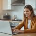 Young woman smiling while applying online for a same-day loan on her laptop